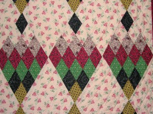 Fai Isle close-up.  Background is my fave pink.   I have heaps of the Green Smithsonian left; Copp Quilt pattern Berry Leaf in Avocado but would give my eye teeth for more of the red.